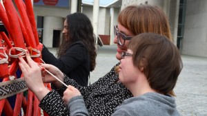 Die Leiterin des Forschungsprojektes Katja de Bragança, die Übersetzerin in klare Sprache, Anne Leichtfuß und Beiratsmitglied Julia Bertmann (v.l.) binden zusammen die letzten Stangen der Jurte fest. Foto: Vera Lisakowski